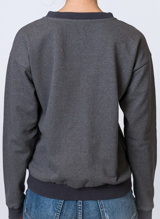 Load image into Gallery viewer, Woman wearing a dark gray crewneck with medium wash jeans. Back of clothing is being shown
