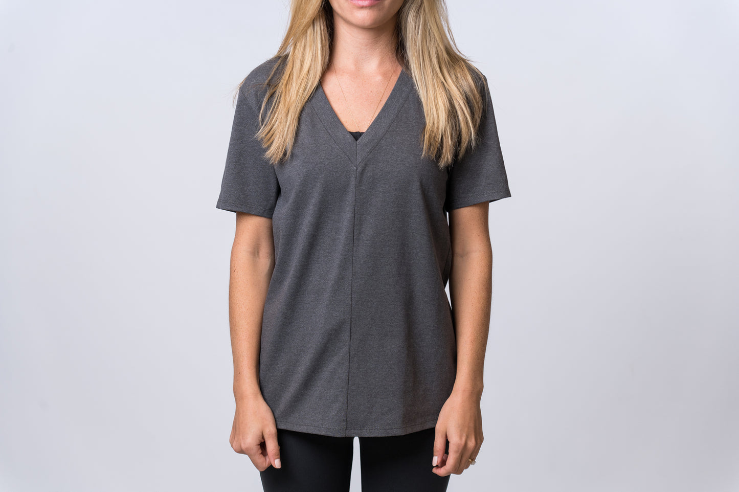 Load image into Gallery viewer, Woman wearing a dark gray, short sleeve shirt with black lounge pants. Front of clothing is being shown

