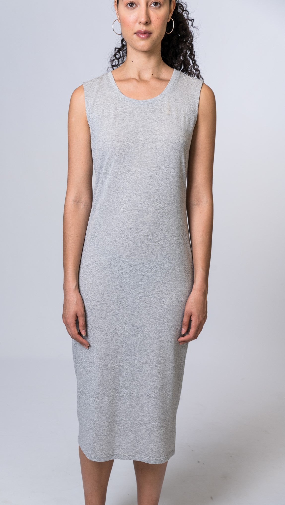 Woman wearing a light gray midi dress. Front of dress is being shown