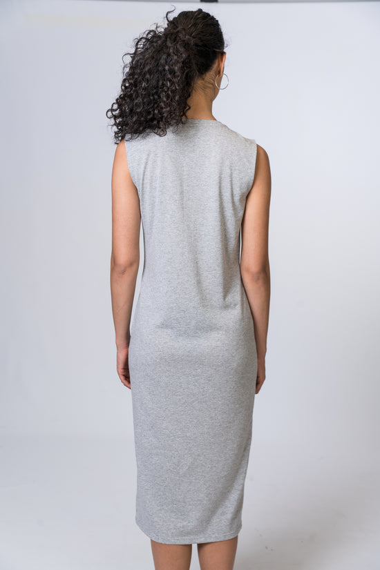 Load image into Gallery viewer, Woman wearing a light gray midi dress. Back of dress is being shown
